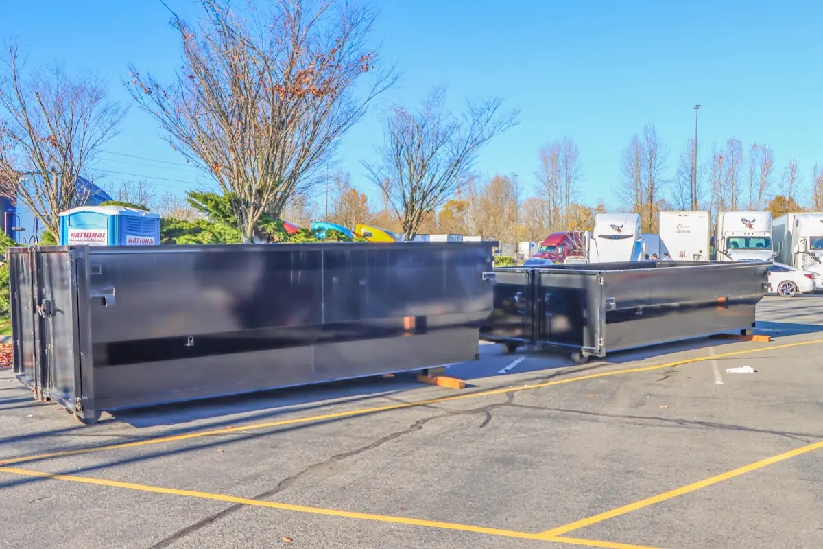 Professional dumpster rental service with roll-off container on residential driveway in Mount Healthy